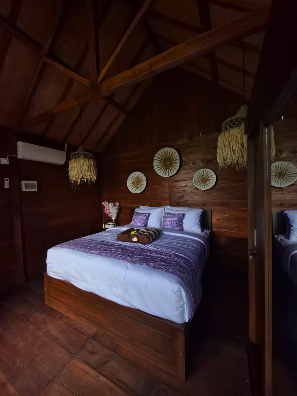 Warm wood villa interior with view to rice fields